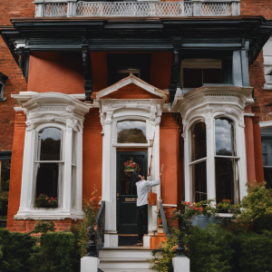 An image featuring a skilled residential painter meticulously applying a fresh coat of paint to a beautifully restored Victorian home in York